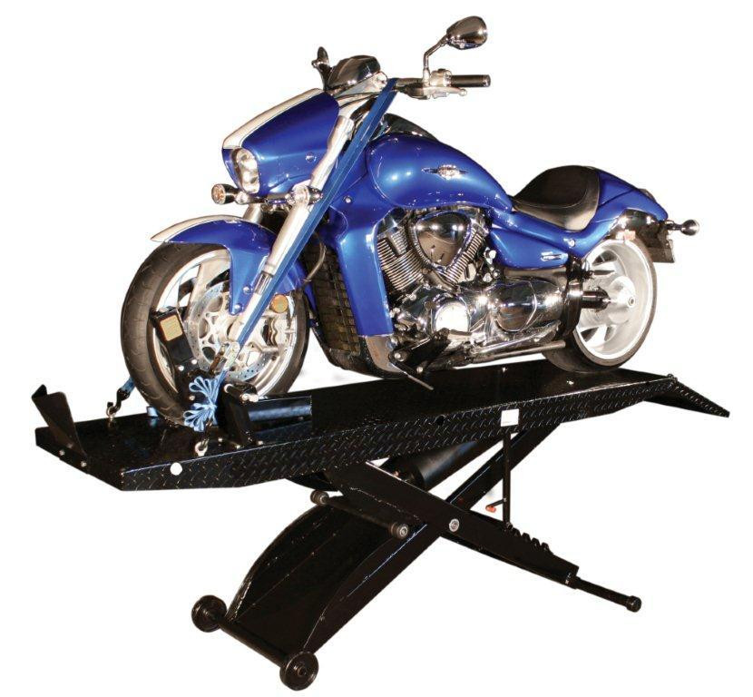 Blue cruiser motorcycle strapped down on a raised Weaver Pro-1000 Droptail lift, showing the black diamond-plate deck, side extensions, and front wheel chock.